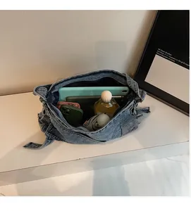Interior view showing large capacity of the denim tote bag with iPad and essentials