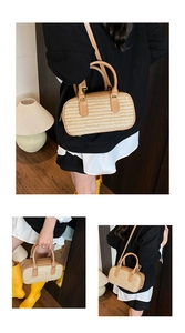 Detail of hand-woven straw bag with leather trim and adjustable shoulder strap