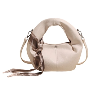 Chic cream dumpling bag with lychee texture leather and a decorative floral silk scarf