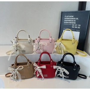 Close-up of six colorful lychee pattern bucket bags with pearl bows and heart charms