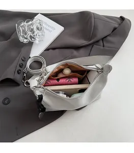 Interior view showing the spacious capacity of this minimalist grey suede shoulder bag