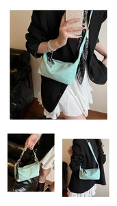 Detail of mint green matte bag featuring heart charm and smooth zipper texture