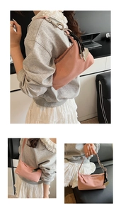 Detailed macro view of pink suede shoulder bag with heart charm and silver chain strap