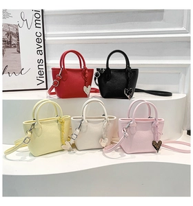 Mini tote bags in five colors with lychee grain texture and heart charms on a white stand
