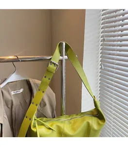 Lime green leather hobo bag with adjustable silver buckle strap and smooth top zipper