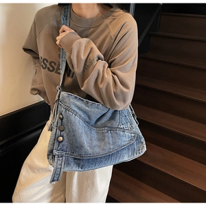 Close-up of retro washed blue denim tote bag with wide adjustable shoulder strap