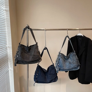 Three vintage denim tote bags in dark grey, navy and light blue with metal rivets