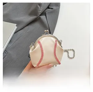 Detailed macro of a baseball-themed mini purse with red stitching and silver ball chain