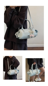 Detail of light blue cylinder bag with pearl beads and pink ribbon bow pendant charm
