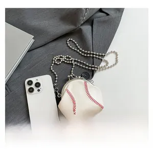 Mini baseball-shaped shoulder bag in white with red stitching detail and metal chain