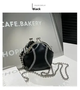Detail of baseball-style shell bag showing white stitching and silver metal chain strap