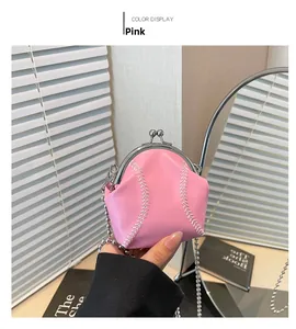 Detail of pink baseball-shaped shell bag featuring silver kiss-lock and chain strap