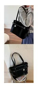 Detail of glossy black tote bag with metal buckle strap and heart-shaped pendant