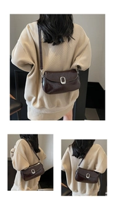 Detail of dark brown leather saddle bag with vintage texture and silver oval buckle