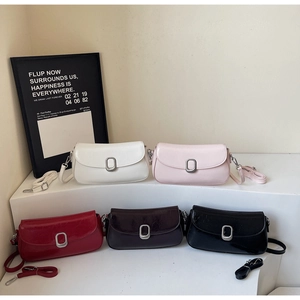 Close-up of stylish faux leather baguette bags in five colors with silver metal buckles