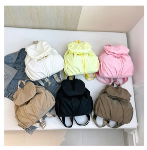 Collage de mochilas plisadas en seis colores que incluyen blanco, beige y negro