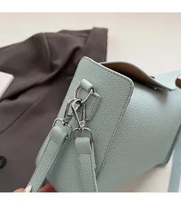Close-up of light blue litchi grain leather bag with premium silver metal hooks