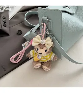 Detail of ShellieMay plush charm with a milk bottle on a blue litchi pattern shoulder bag