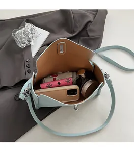 Spacious interior of light blue lychee pattern crossbody bag showing daily essentials