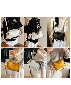 Litchi texture underarm bags in multiple colors with metallic turn-lock and bear charms