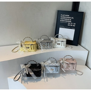 Mini quilted box bags in multiple colors with pearl handles and lace bow details