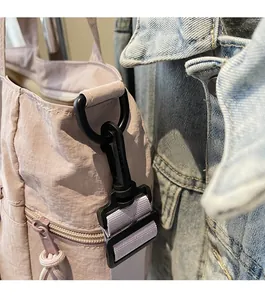 Detail of durable black shoulder strap hook on lavender nylon tote bag with zip pocket