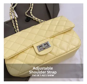 Detail view of yellow quilted crossbody bag with metal twist lock and chain strap