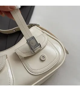 Dettaglio borsa sottobraccio in pelle bianco avorio con patta e fibbia magnetica