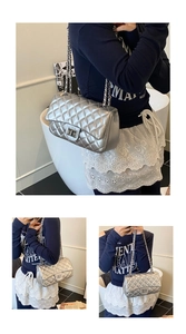 Detail of silver quilted chain bag with metallic finish and classic turn-lock closure
