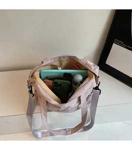 Detailed interior of nylon tote bag showing spacious capacity for tablets and umbrellas