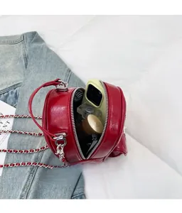 Macro view of a red quilted chain bag interior showing storage space for daily essentials