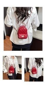 Close-up of red quilted mini backpack with glossy finish and gold chain shoulder straps