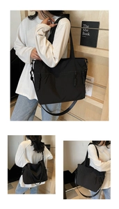 Detail of black nylon tote bag featuring functional metal zippers and woven pullers