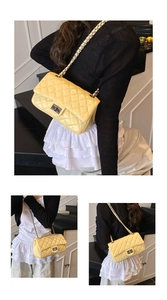 Detail of yellow quilted crossbody bag with silver twist lock and chain strap