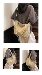 Detail of nylon tote bag showing braided rope zipper pulls and front zipper pocket