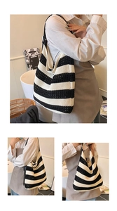 Detail of black and white striped hollow knit tote bag with premium shoulder strap