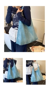 Detail of light blue hobo tote bag featuring a distressed washed finish and spacious design