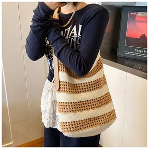 Detail of hollow knit tote bag with brown stripes and durable leather shoulder strap