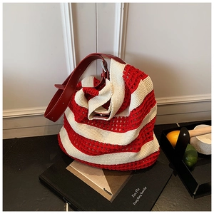 Detail of red and cream knit tote bag with mesh texture and leather strap