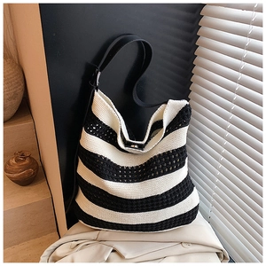 Detail of hollow knit texture and black and white stripes on this stylish tote bag