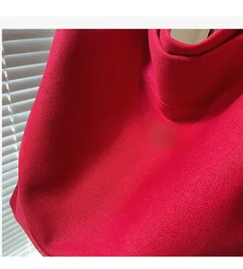 Close-up of red washed canvas fabric showing high-density woven texture on tote bag