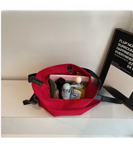 Detail view of the large capacity red canvas bag showing interior storage for tablets and items