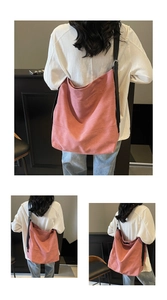 Detail view of pink canvas hobo tote with adjustable black strap and metal buckle