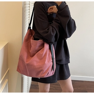 Detailed view of the large Morandi pink canvas tote bag with black leather shoulder straps