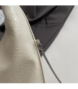 Detailed macro of premium silver hardware buckle and pleated leather texture of this bag