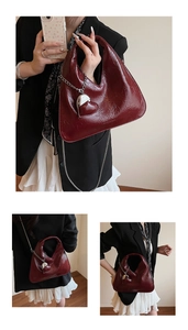 Macro view of burgundy wrinkled patent leather texture and silver heart charm on bag