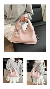 Detail of pink pleated hobo bag with silver chain strap and a cute heart leather charm