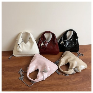 Close-up of heart charm detail and wrinkled leather texture on hobo bags in five colors