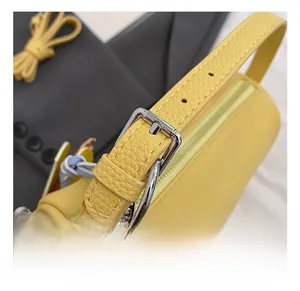 Detail of yellow lychee grain leather with silver metal buckle and beaded chain accents