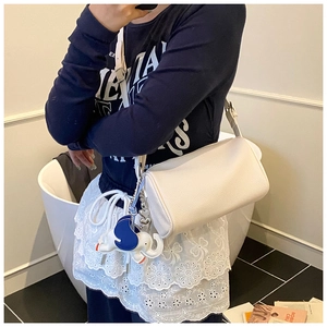 White cylinder bag with lychee texture featuring a blue and white elephant charm detail